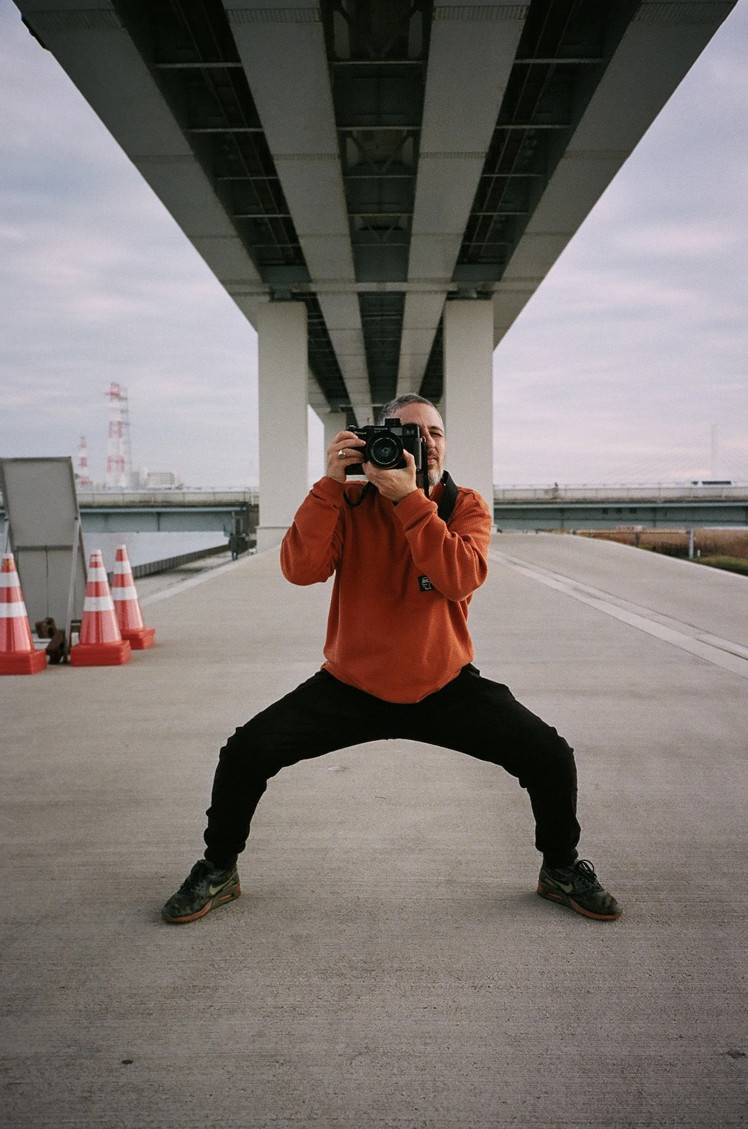 Michael Medoway with a rangefinder, under a bridge